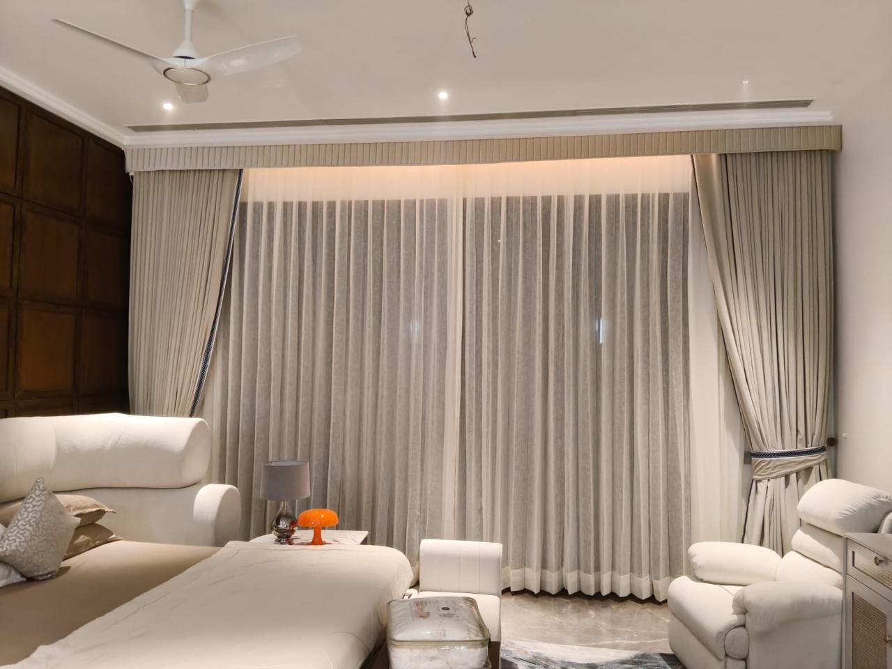 Light curtains and layered drapes in a living room.
