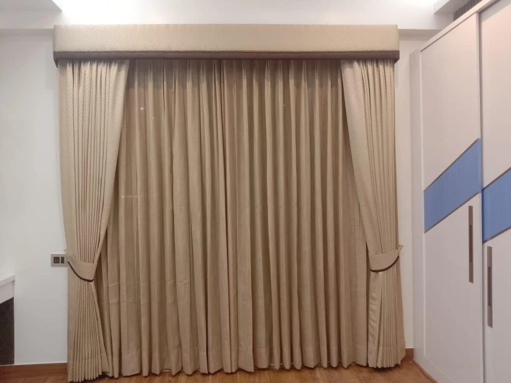 Warm neutral curtains fitted across a wide window.