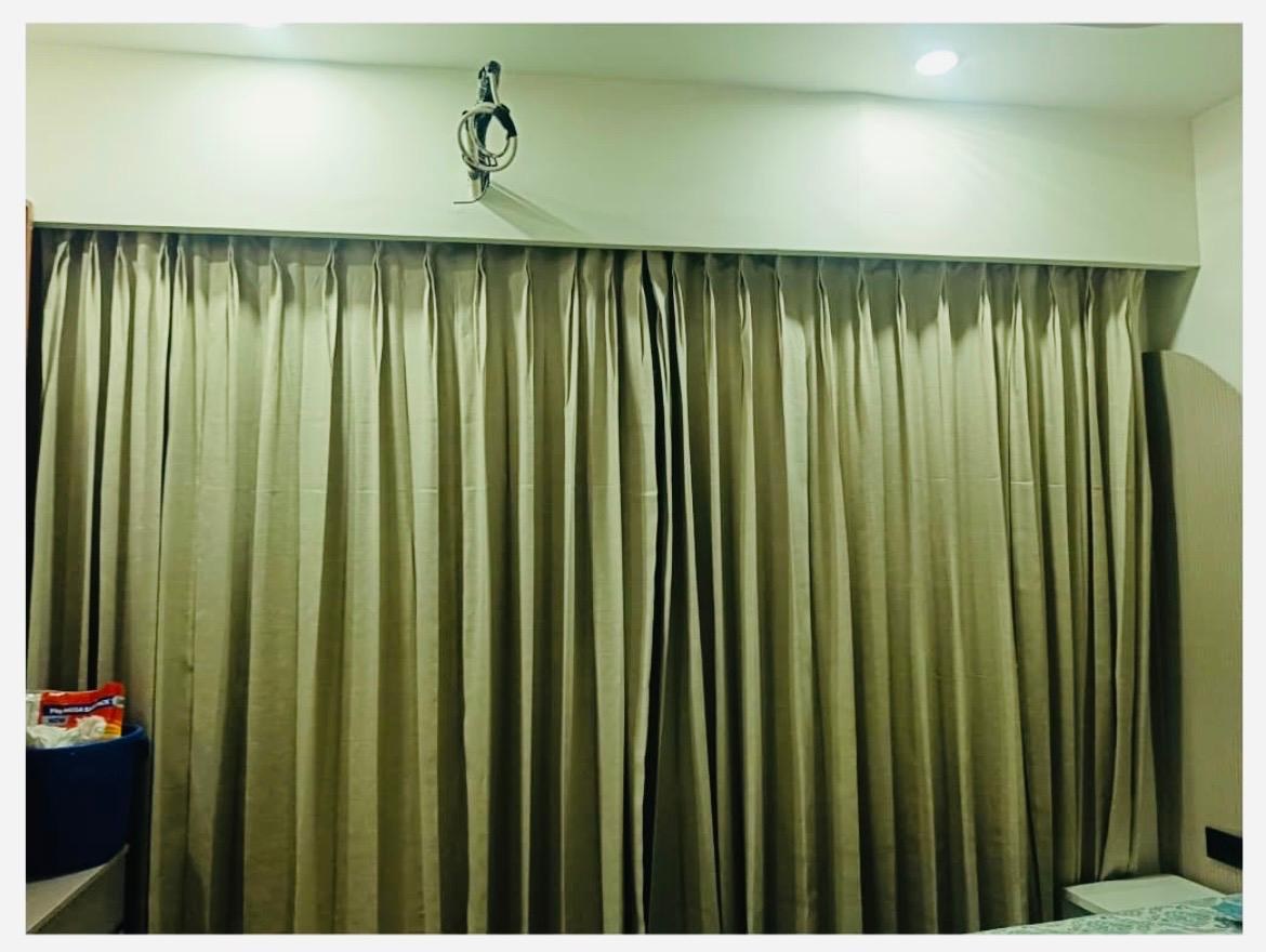Muted green curtains with generous folds.